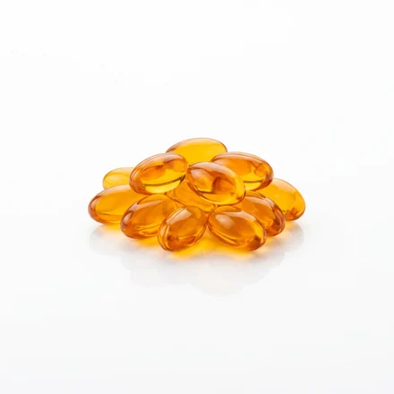 Cluster of amber gel capsules representing Nicotinamide, vitamin B3
